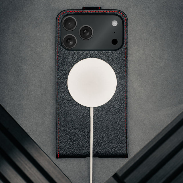 MagSafe charger attached to the Black with Red Stitching Leather Flip Case for iPhone 17 Pro