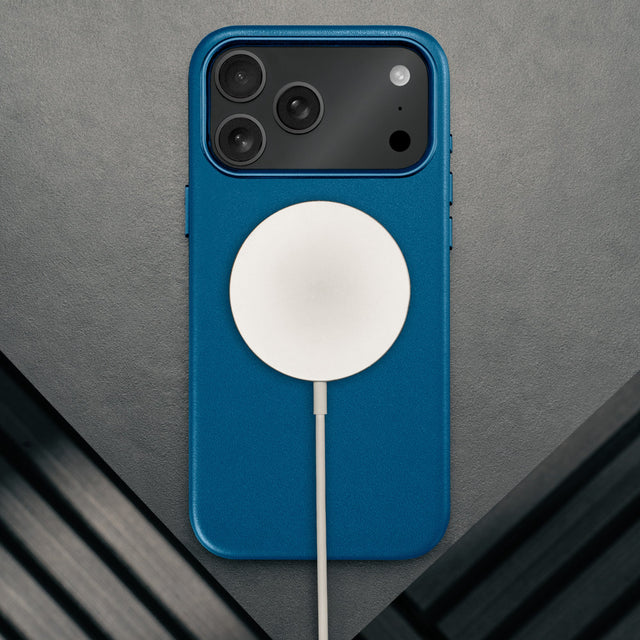MagSafe charger attached to the Slimline Cobalt Blue Leather Bumper Case for iPhone 17 Pro Max