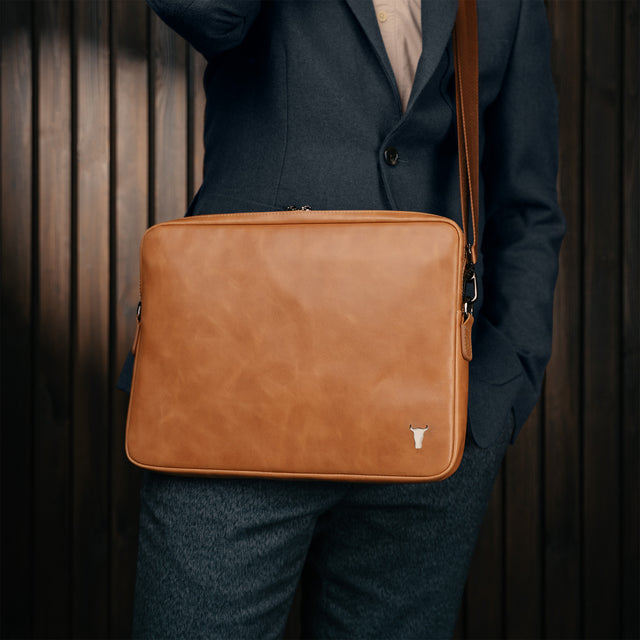 Man carrying the Tan Leather Messenger Bag